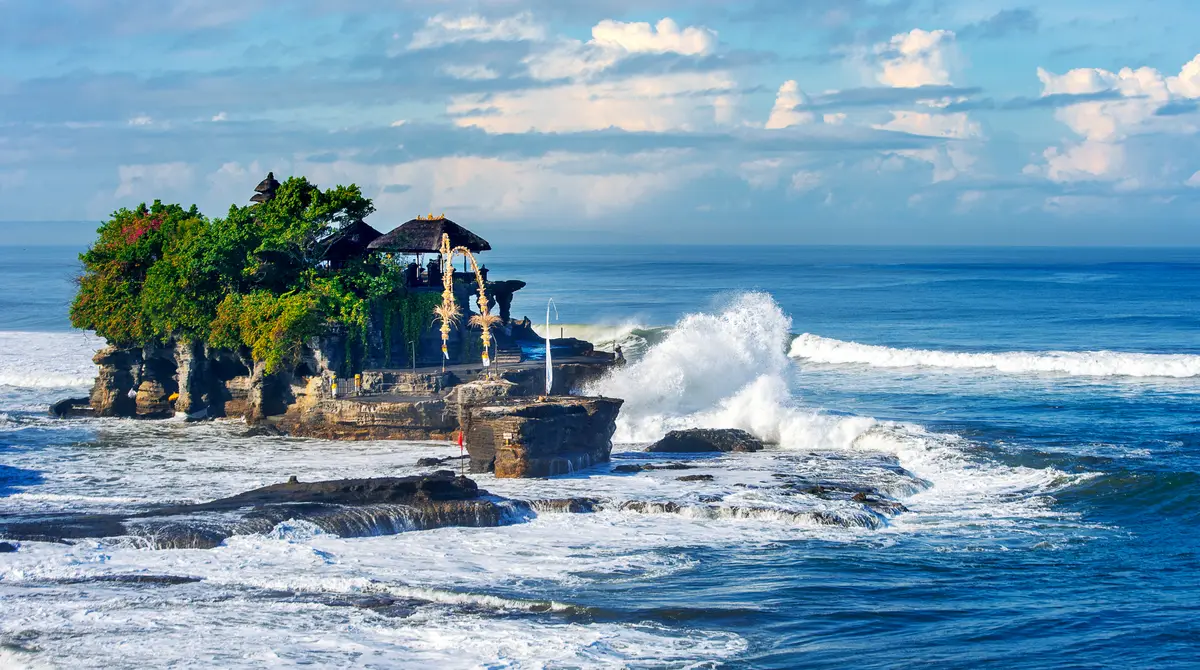 Tanah Lot temple on a rock in the sea at sunset in Bali, Indonesia