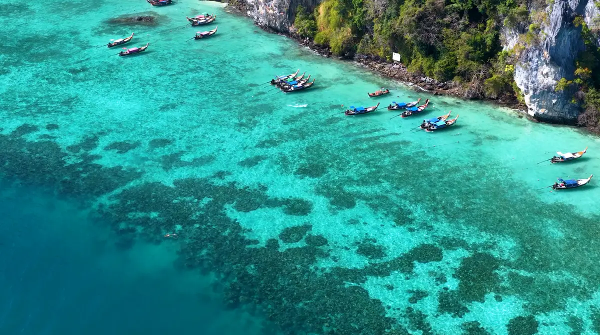 Aerial view of green limestone islands in a turquoise sea in Thailand